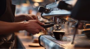 Barista pulling an espresso shot into a cup on a coffee machine.